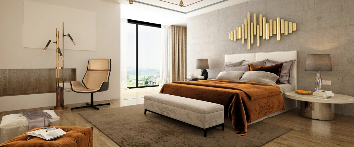 A modern luxury bedroom featuring a plush bed with rust-colored velvet bedding, a sleek armchair, striking gold wall art, and a large window overlooking a scenic landscape.