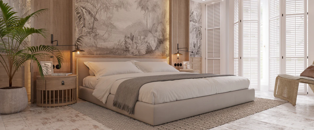 A serene tropical-inspired bedroom featuring a low platform bed with white linens, palm tree motif wallpaper, wooden accent paneling, a potted indoor plant, and white louvered doors.